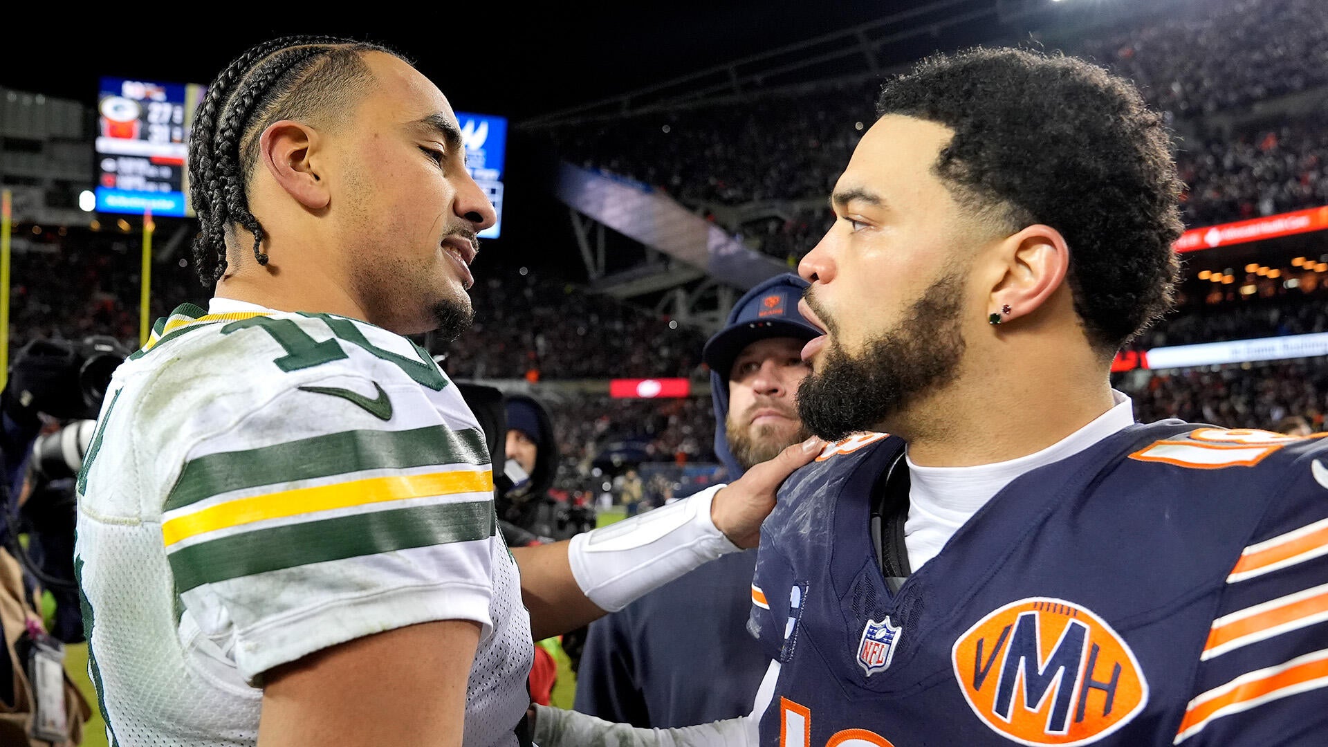 Packers QB Jordan Love and Bears QB Caleb Williams shake hands after a 2025 playoff game.