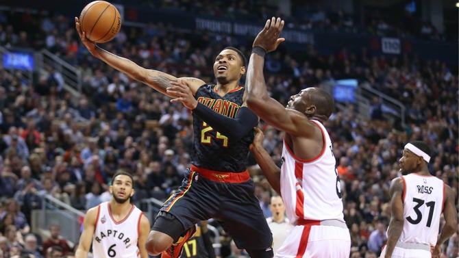 Kent Bazemore tries to score over Bismack Biyombo