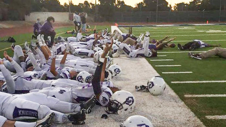 LOOK: Kaepernick kneels at high school game while players protest on their backs