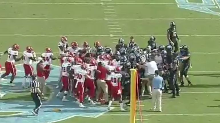 Watch as NC State and North Carolina benches clear over an incomplete pass