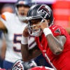 Falcons' QB Tua Tagovailoa lines up under center during a preseason game and makes a pre-snap call.