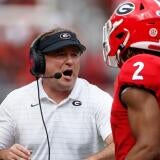 Georgia coach Kirby Smart celebrates with Georgia running back Kendall Milton (2) after he scored a touchdown during the first