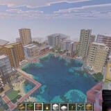 Mike Tomlin is in a split screen box describing his virtual Minecraft city, which includes a vast lake, urban architecture, and a massive city.
