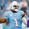 Titans QB Cam Ward, wearing a number 1 blue jersey, winds up to throw a football.