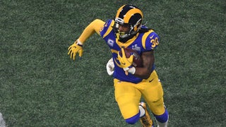 Los Angeles Rams running back Todd Gurley spits water as he sits