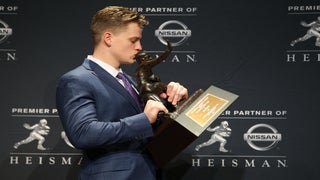 Heisman winner Joe Burrow reacts after receiving a Bengals helmet from  former NFL MVP Boomer Esiason 