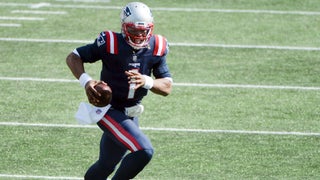 Cam Newton of the New England Patriots throws the ball in the second