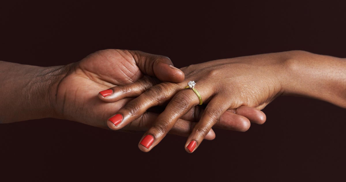 black-woman-with-engagement-ring-holding-fiancees-hand