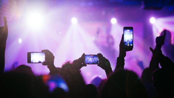 people-taking-videos-and-photos-of-band-using-smartphones