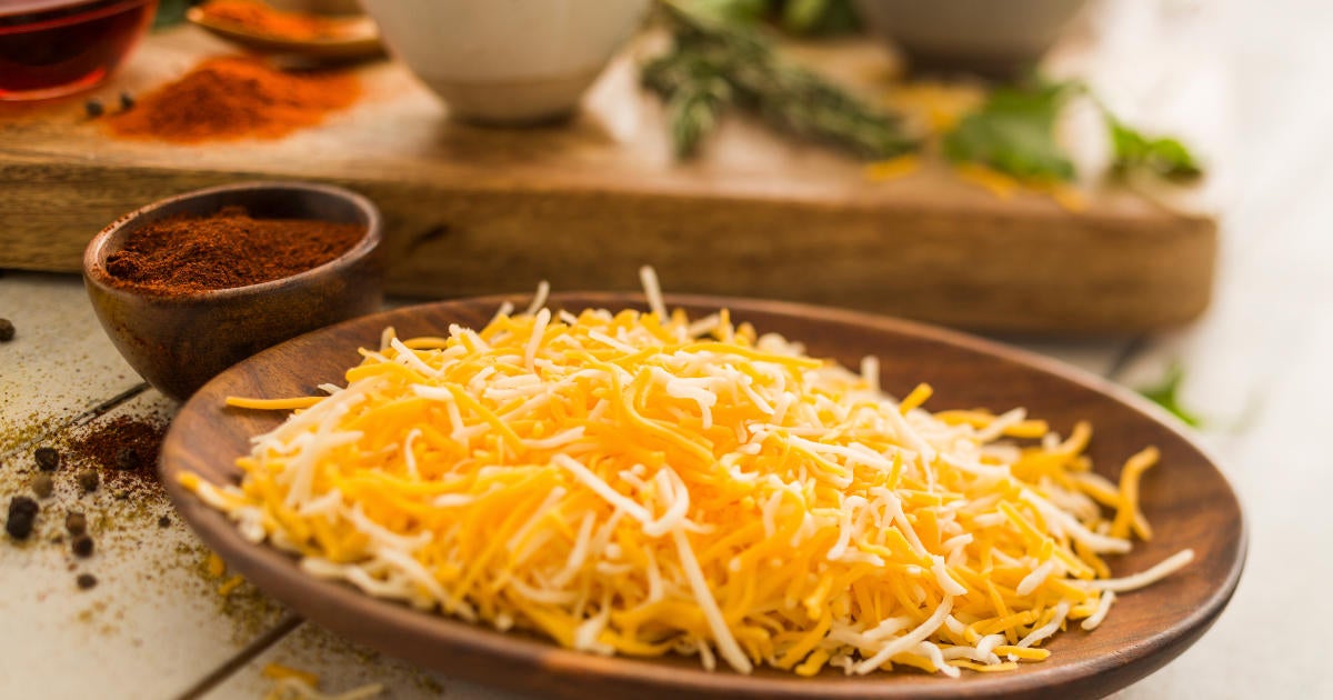 shredded-cheese-on-wooden-plate