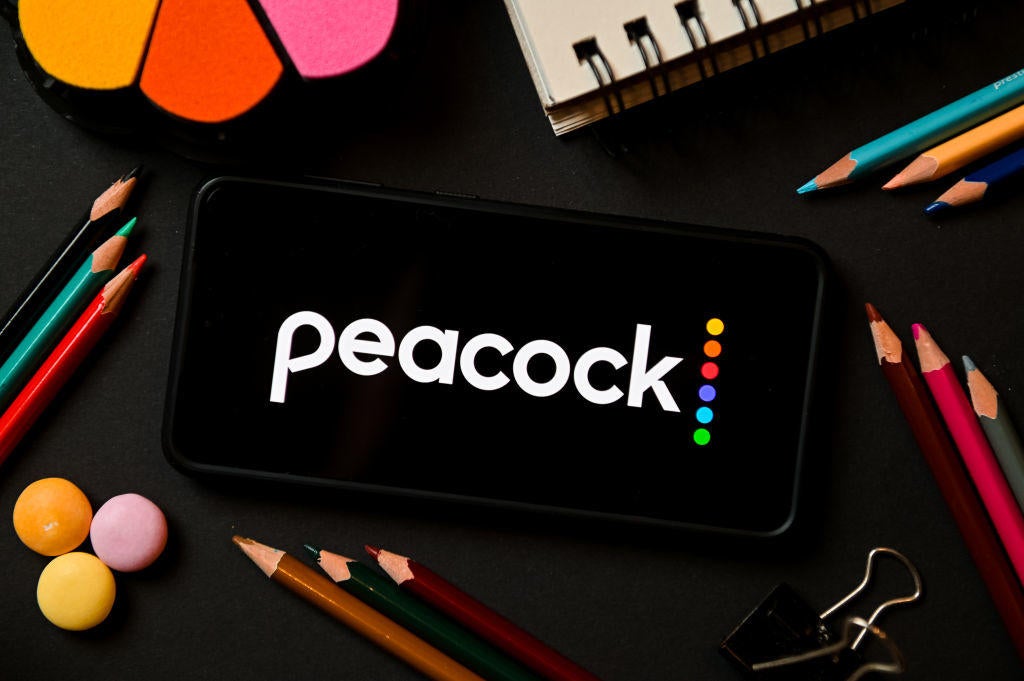 In this photo illustration a Peacock logo seen displayed on