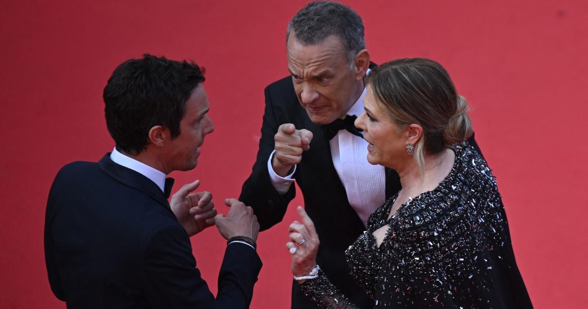 Tom Hanks cuts a dapper figure as he poses with wife Rita and son