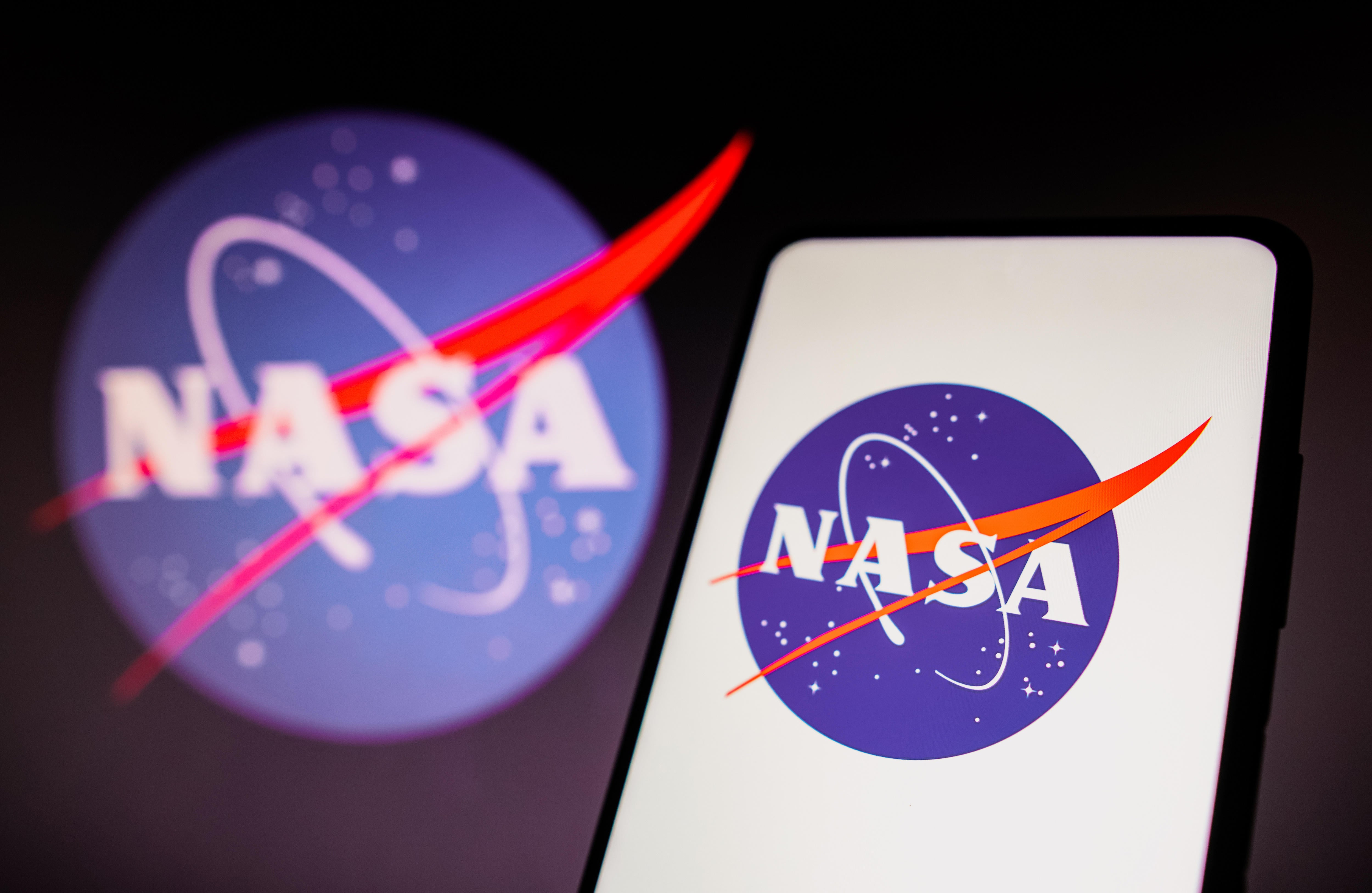 In this photo illustration, the NASA logo is displayed on a