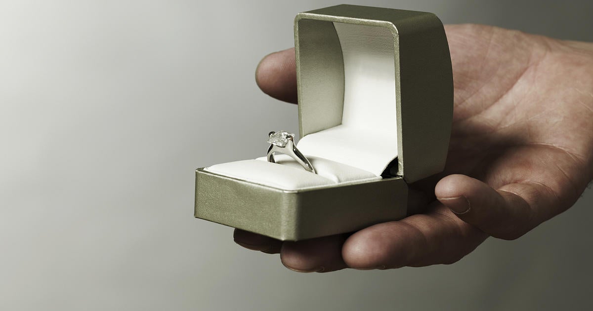 man-holding-engagement-ring