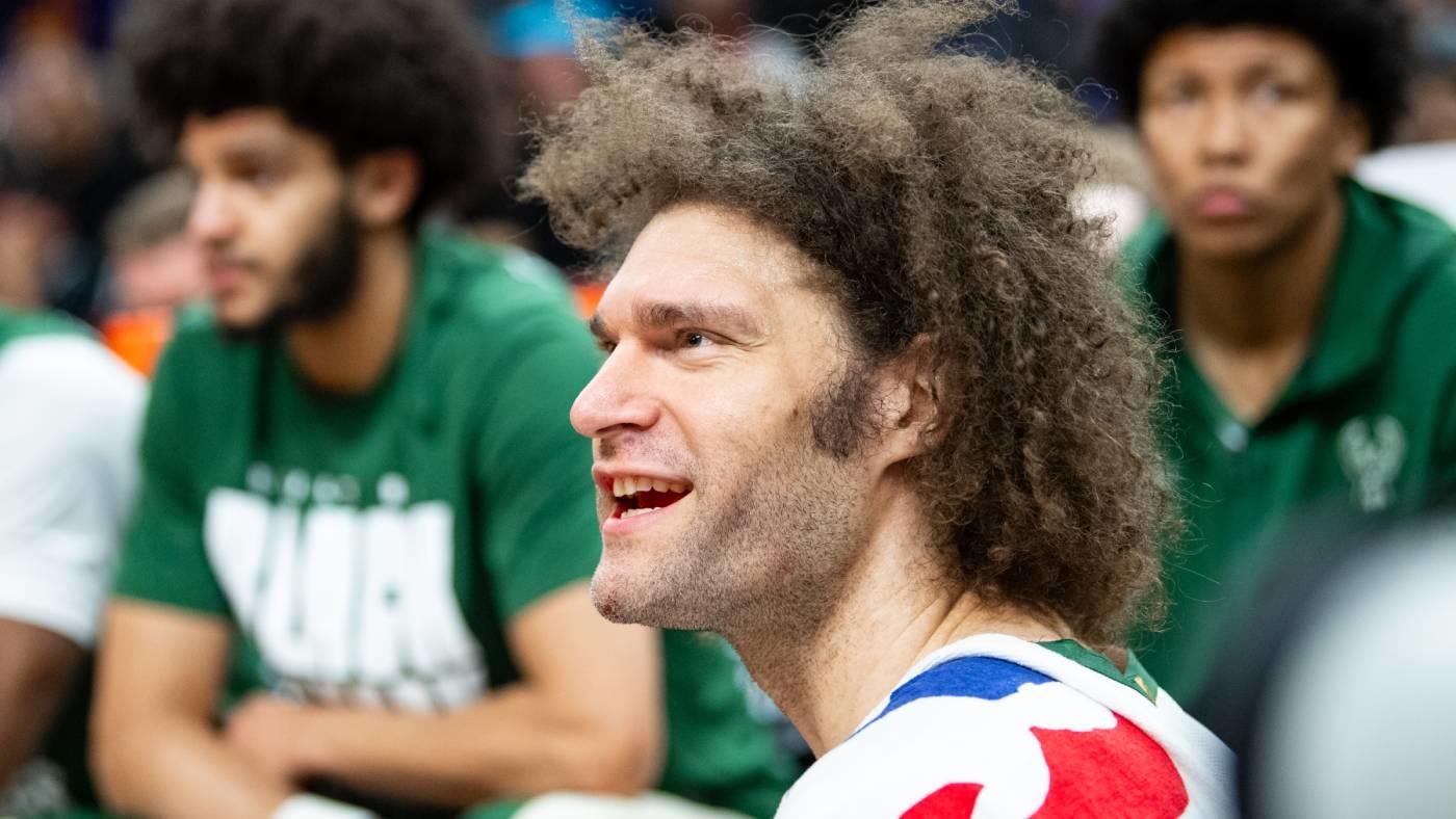 LOOK: Robin Lopez sits courtside, reads a book during Bucks game after getting traded