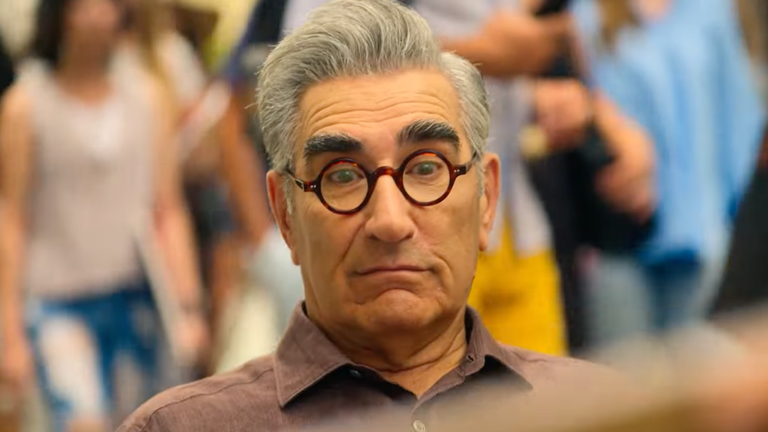 See Eugene Levy's Hilarious Reaction To Having His Caricature Drawn 'The Reluctant Traveler' Exclusive Sneak Peek