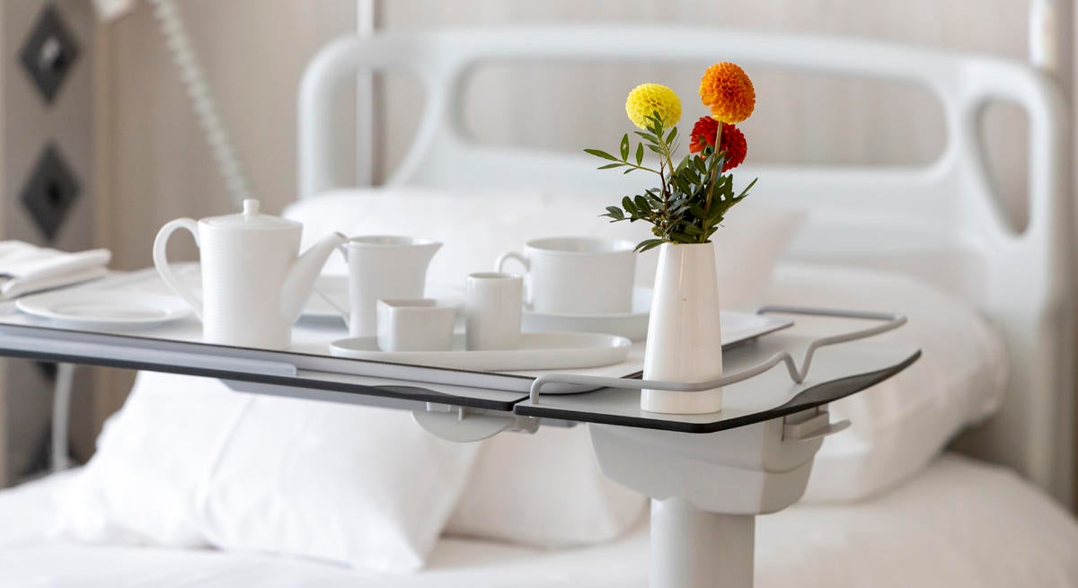 a hospital bedside table, with a meal tray