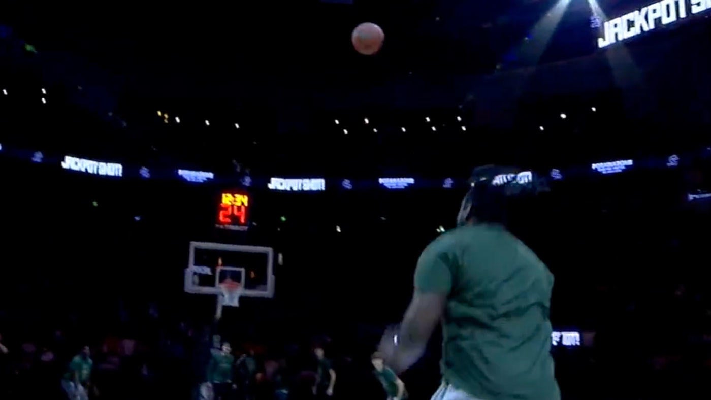 LOOK: Bucks fan hits insane half court shot off the top of the backboard to win $10,000