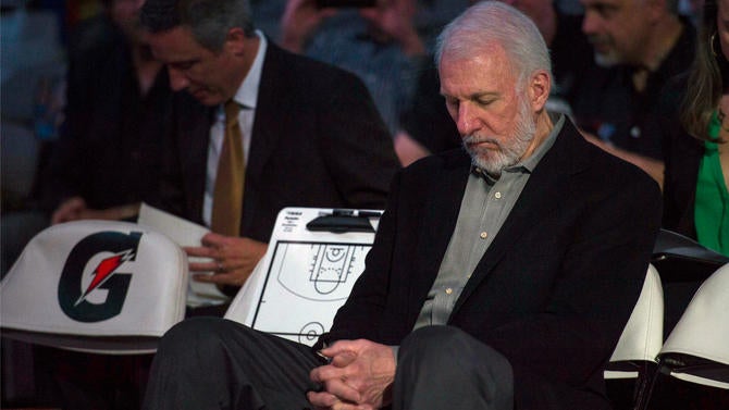 Spurs coach Gregg Popovich sits silently