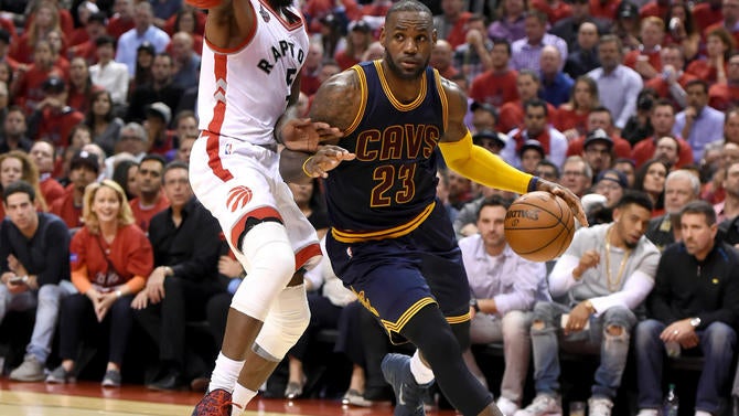 LeBron James drives against DeMarre Carroll