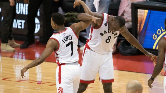 Kyle Lowry and Bismack Biyombo celebrate winning Game 4