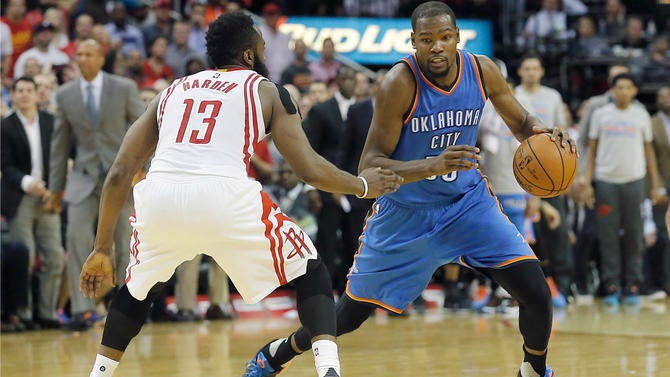 Kevin Durant is guarded by James Harden in Houston