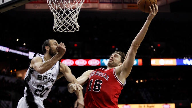 Pau Gasol goes for a layup against Manu Ginobili