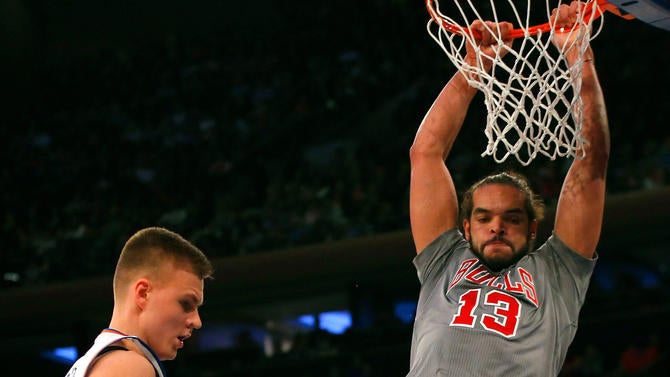 Joakim Noah dunks near Kristaps Porzingis at MSG