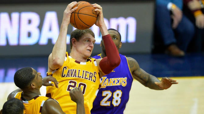 Timofey Mozgov grabs a rebound against the Lakers