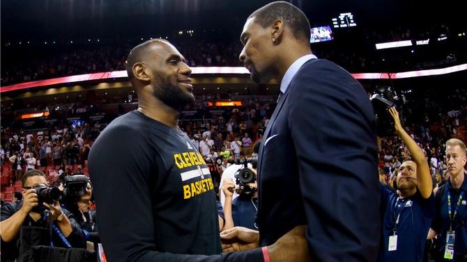 LeBron James and Chris Bosh talk after a game