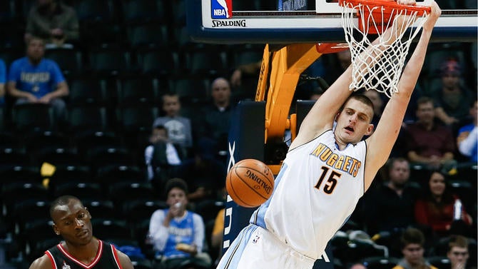 Nikola Jokic hangs on the rim
