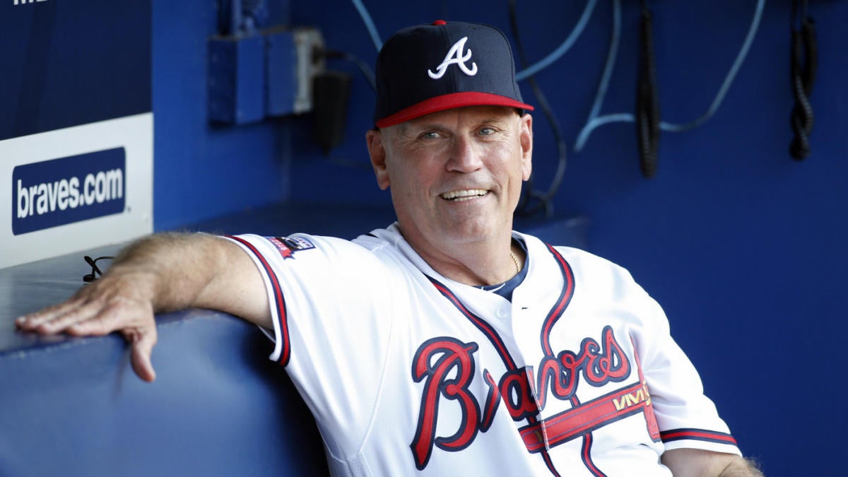 Atlanta Braves manager Brian Snitker signs an autograph before a