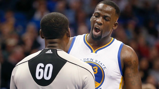 Draymond Green talks to a ref