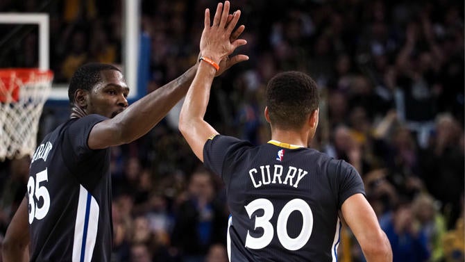 Kevin Durant and Stephen Curry high fiving