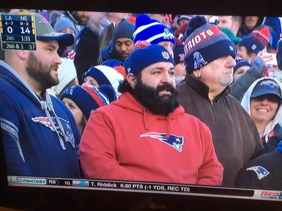 A New England Patriots fan wears a hat shaped like a Super Bowl