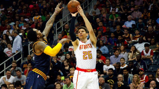 Kyle Korver shoots over J.R. Smith