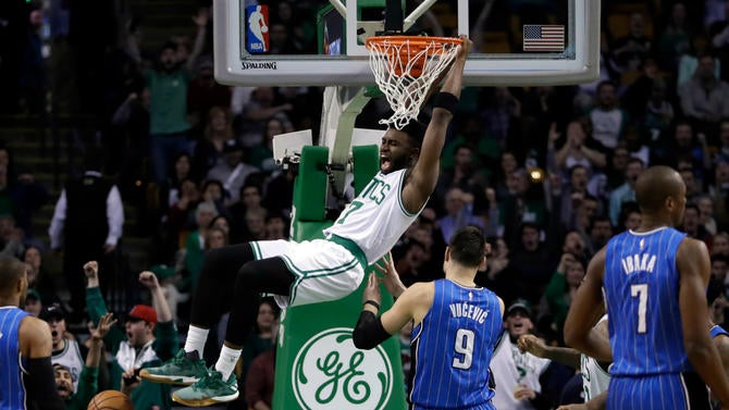 Jaylen Brown hangs on the rim