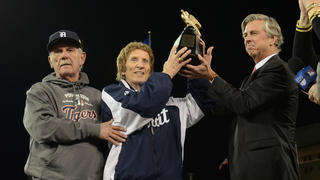 Detroit Tigers pitching coach Bob Cluck, left, reaches out to