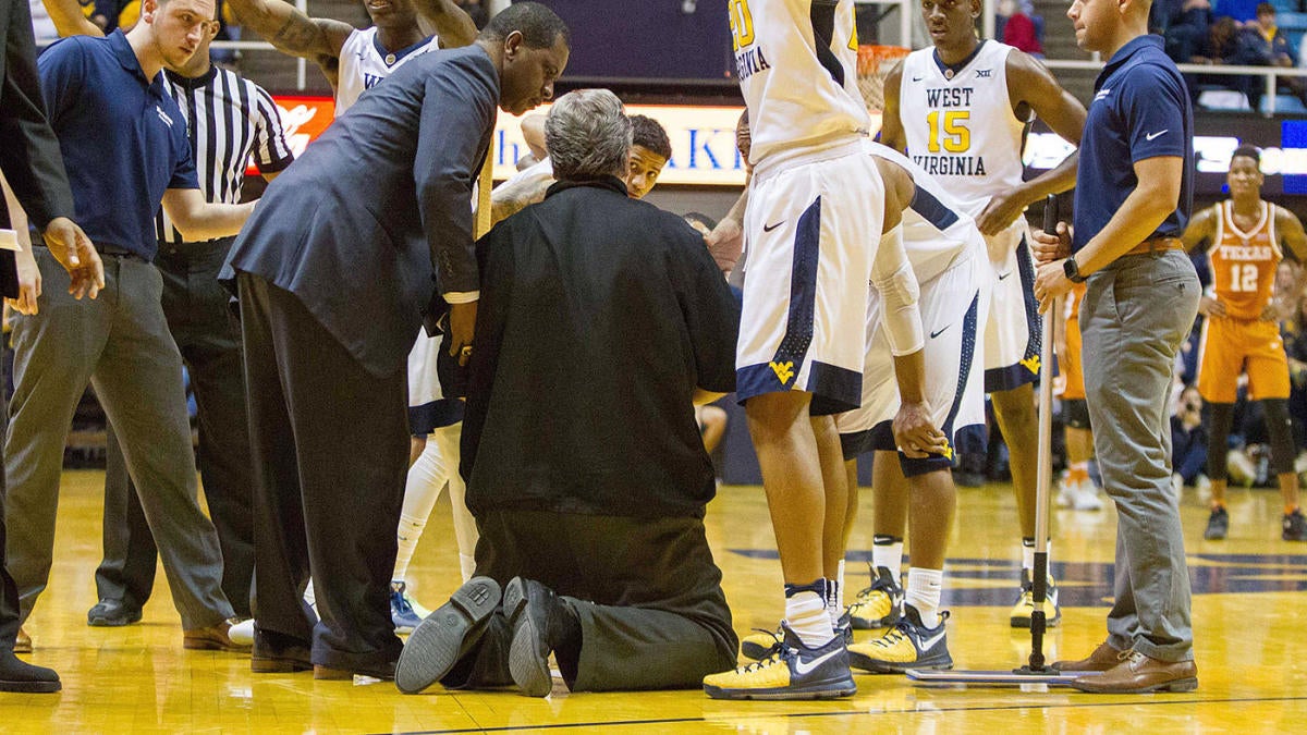 WATCH: Bob Huggins drops to knees, tended to by medical staff during game -  