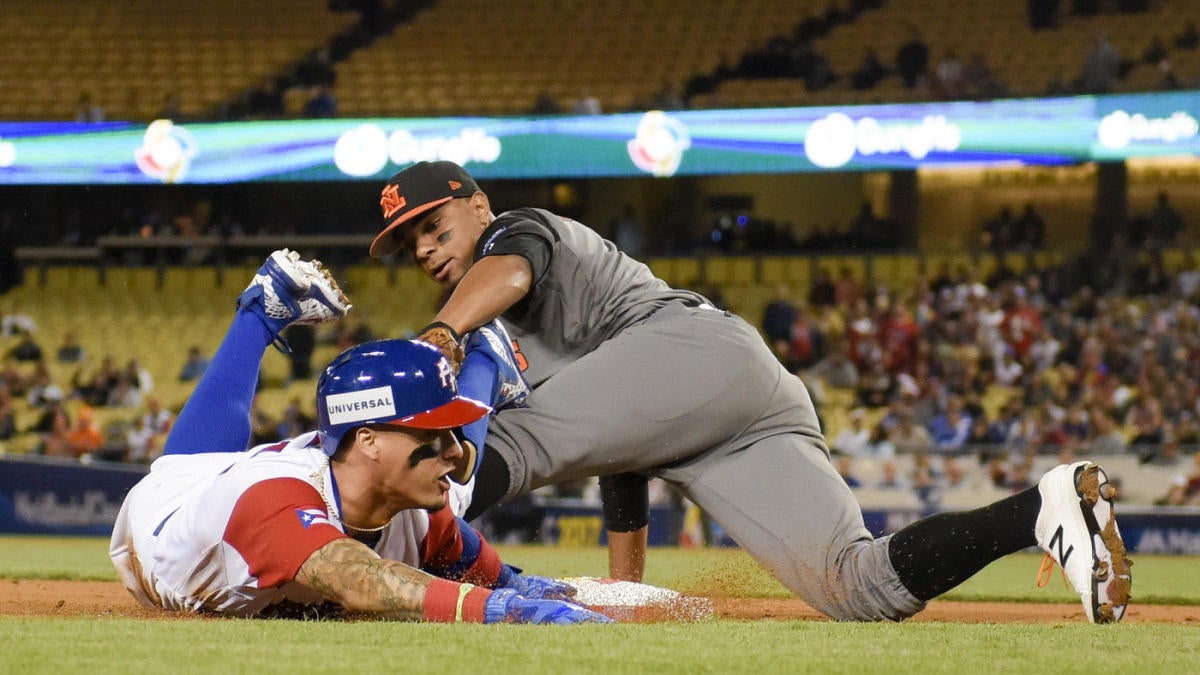 LOS ANGELES, CA - MARCH 20: Puerto Rico second baseman Javier Báez reacts  after sliding safely under a tag by Netherlands Xander Bogaerts ( 1 )  during the game on March 20