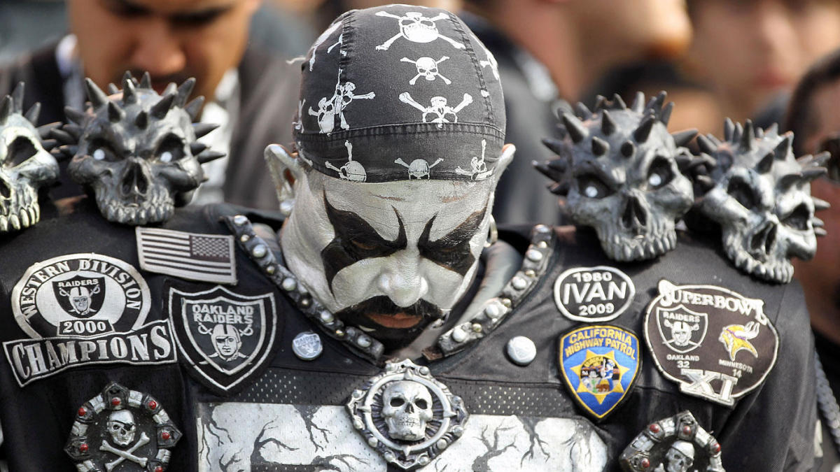 Oakland Raiders fans dressed in costumes arrive at the Oakland