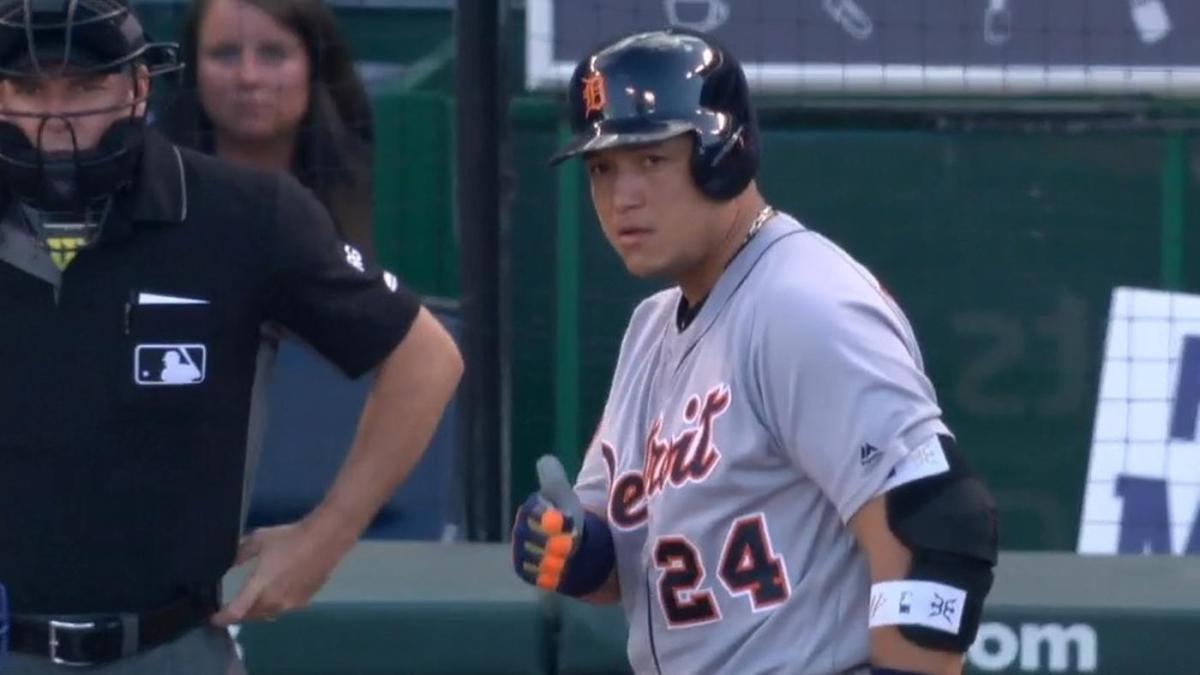 Miguel Cabrera uses his glove to lovingly inspect a fan's beard