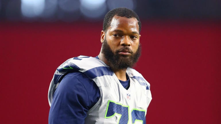 Seahawks' Michael Bennett takes a seat during the national 