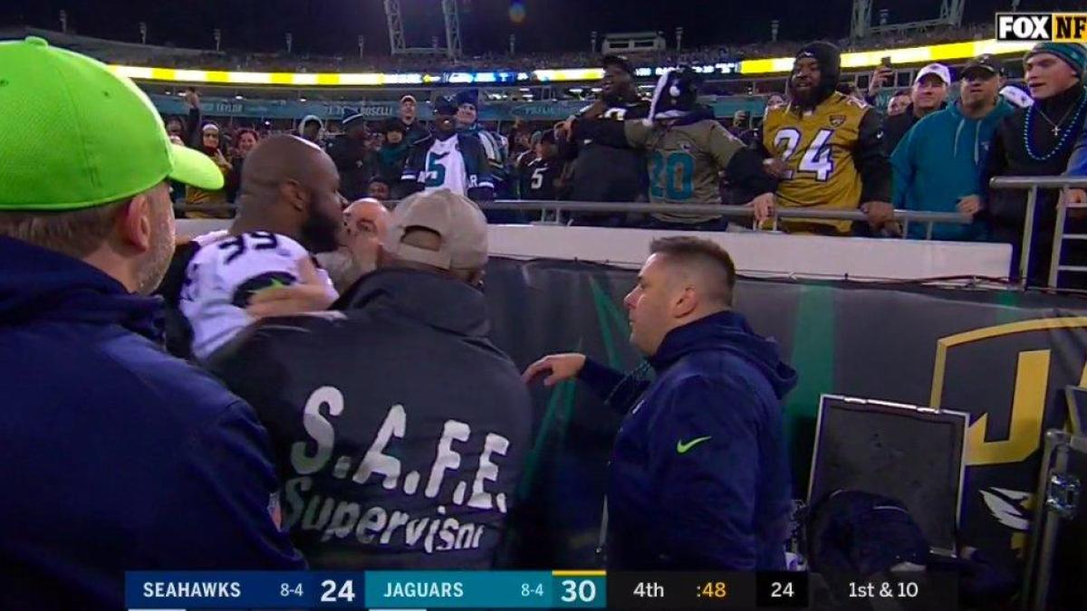 Seahawks' Quinton Jefferson tries to climb into stands to confront fans