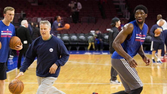 Brett Brown works with Joel Embiid in 2015.