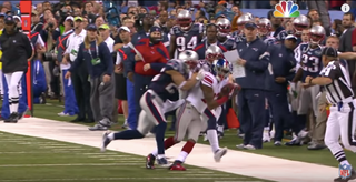 New York Giants receiver David Tyree (85) hauls in a long pass against the  New England Patriots' Rodney Harrison (37) on the game-winning drive in a  17-14 victory over the New England