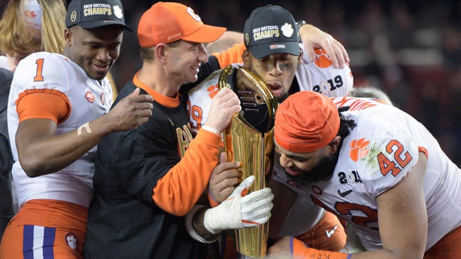 clemson-hugging-cfp-trophy.jpg