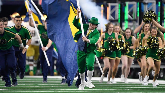 Notre Dame cheerleading squad and mascot practicing before