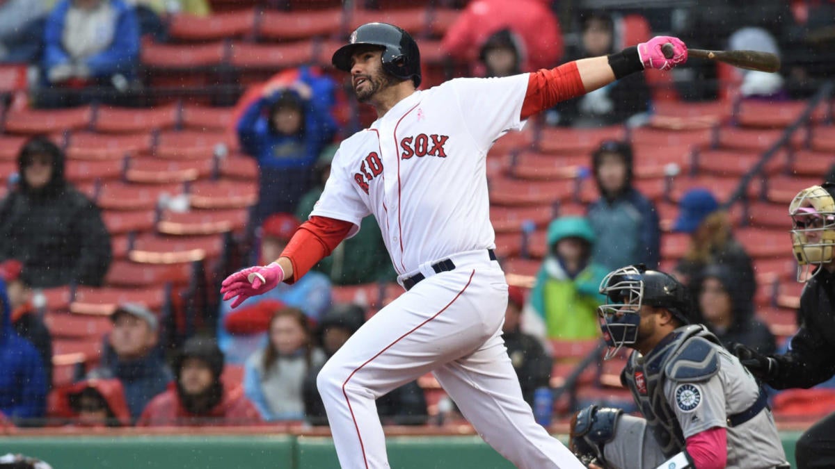 J.D. Martinez of the Boston Red Sox is pushed in a laundry cart