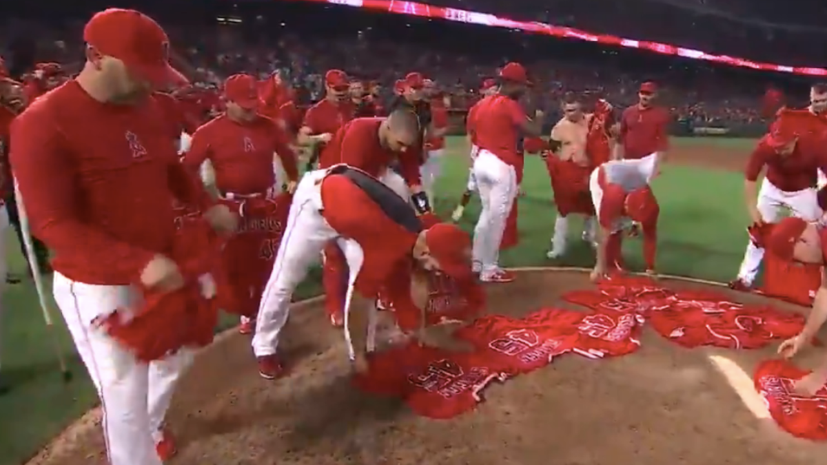 Members of the Los Angeles Angels place their jerseys with No. 45 in honor  of pitcher Tyler Skaggs on the mound after a combined no-hitter against the  Seattle Mariners during a baseball